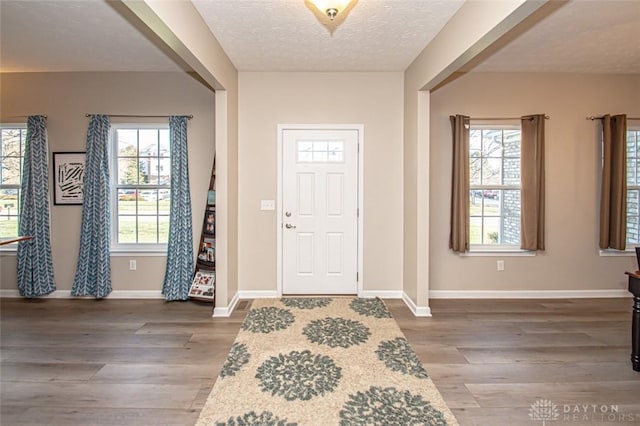 foyer entrance featuring hardwood / wood-style floors and a textured ceiling