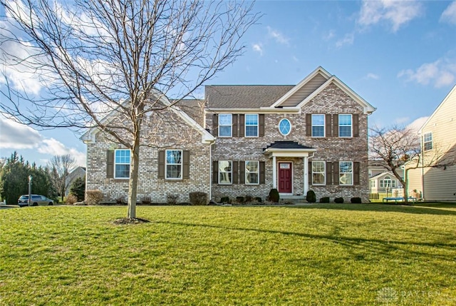 colonial-style house with a front lawn