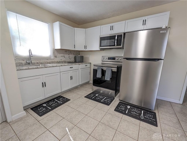 kitchen featuring white cabinets, sink, and appliances with stainless steel finishes