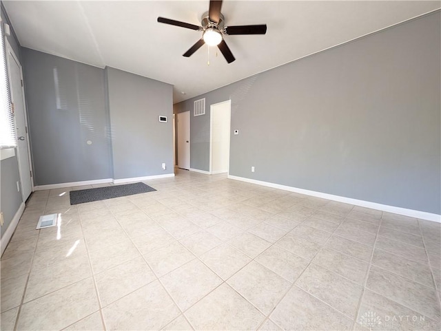 spare room with ceiling fan and light tile patterned flooring