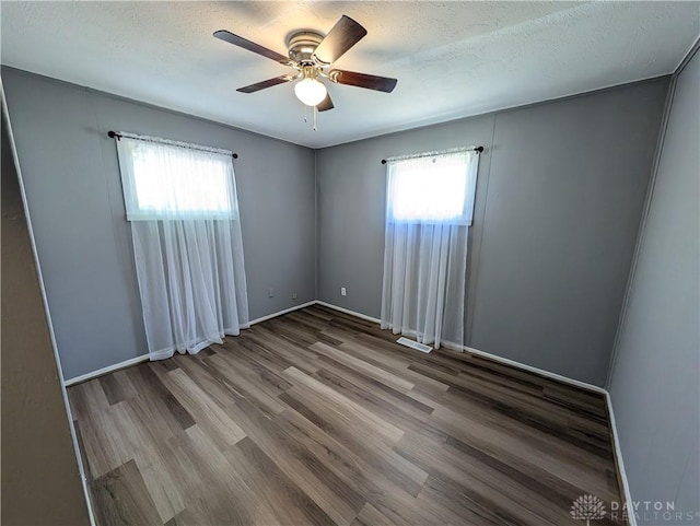 unfurnished room featuring hardwood / wood-style floors, a textured ceiling, and ceiling fan