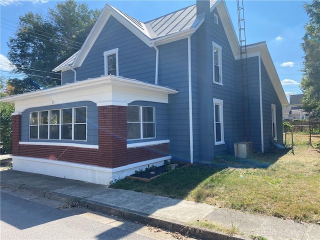 view of property exterior with a yard