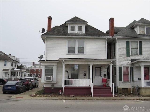 view of front of property featuring covered porch and cooling unit