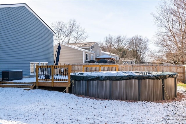 exterior space with central air condition unit and a covered pool