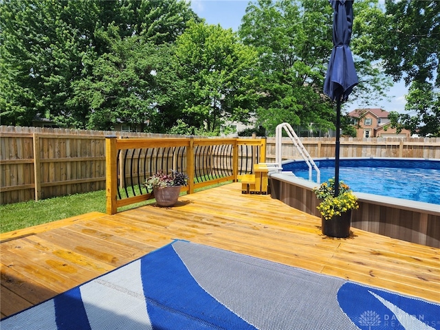 deck with a fenced in pool