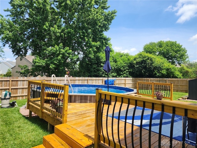 wooden deck with a fenced in pool