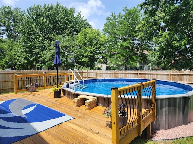 view of swimming pool featuring a wooden deck