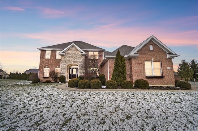 view of front of home featuring stone siding and brick siding