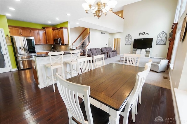 dining area with dark hardwood / wood-style flooring and a chandelier