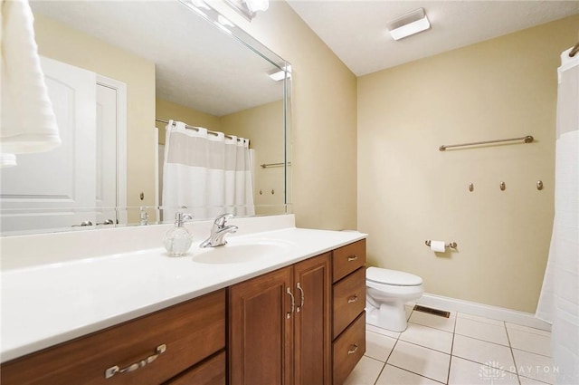 bathroom with tile patterned floors, vanity, and toilet