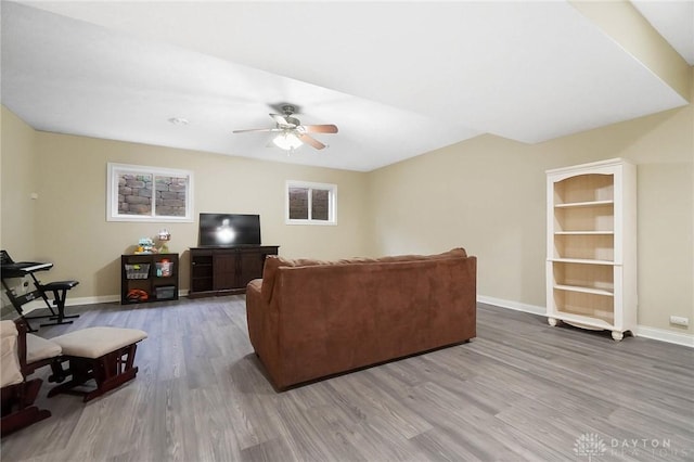 living room with hardwood / wood-style flooring and ceiling fan