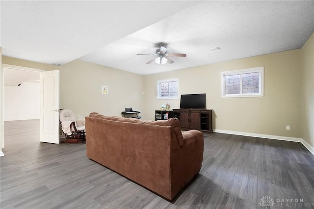 living room with wood-type flooring and ceiling fan