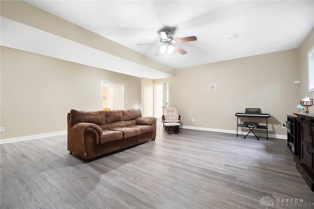 living room featuring ceiling fan and wood-type flooring