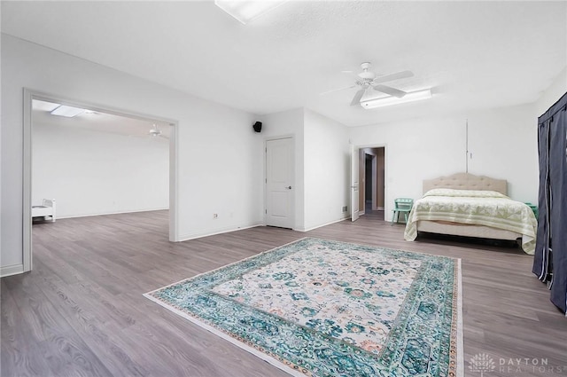 bedroom with ceiling fan and hardwood / wood-style floors