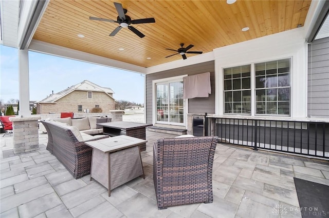 view of patio with an outdoor living space and ceiling fan