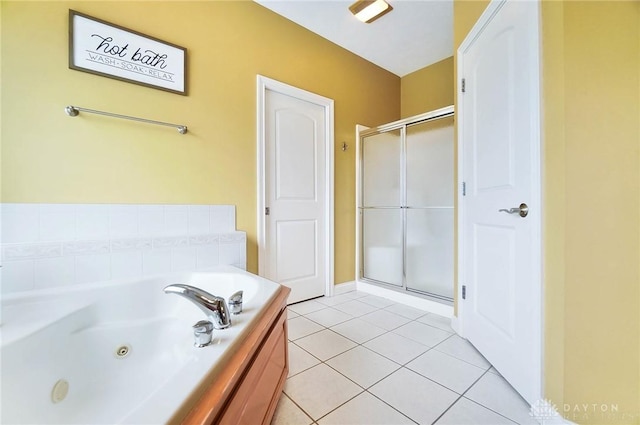 full bath with tile patterned flooring, a tub with jets, and a shower stall