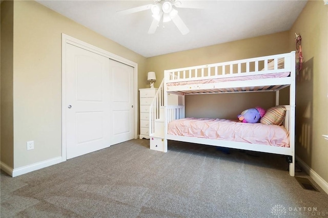 unfurnished bedroom featuring ceiling fan, a closet, carpet flooring, and baseboards