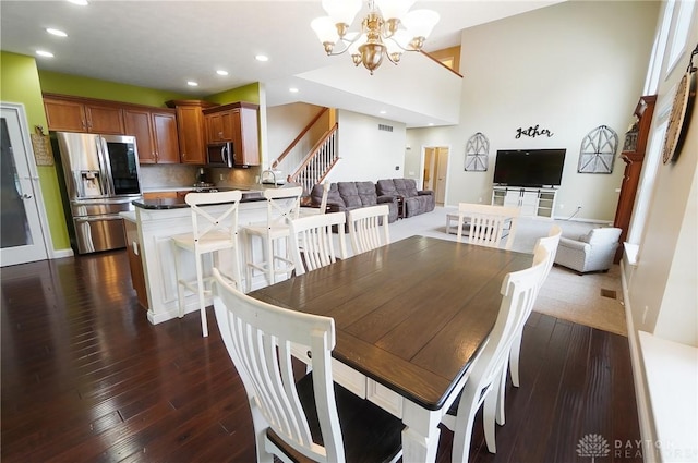 dining room with a chandelier, dark wood-type flooring, stairway, and recessed lighting