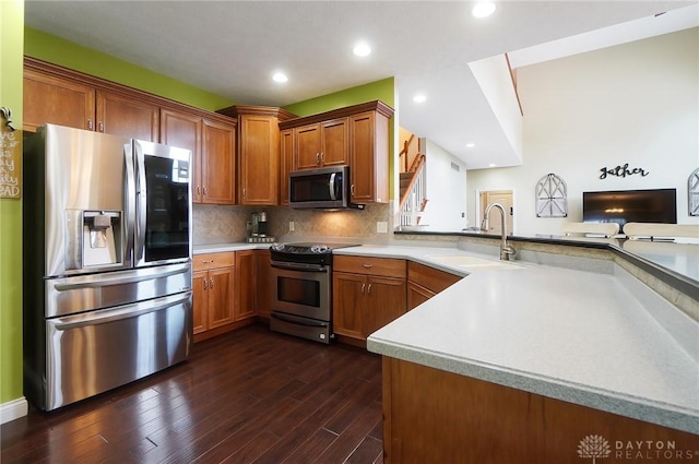 kitchen with brown cabinetry, appliances with stainless steel finishes, and light countertops