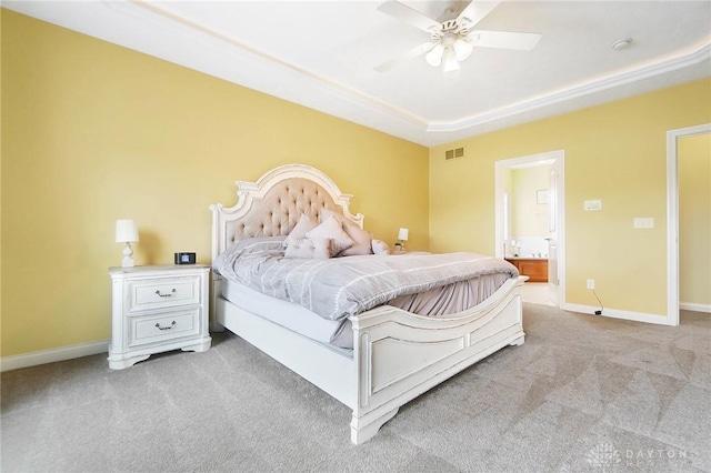 bedroom with visible vents, ensuite bathroom, light carpet, ceiling fan, and baseboards