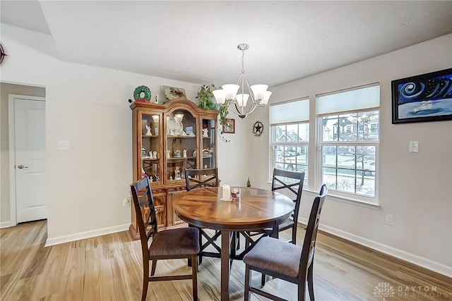 dining room featuring light hardwood / wood-style floors and an inviting chandelier