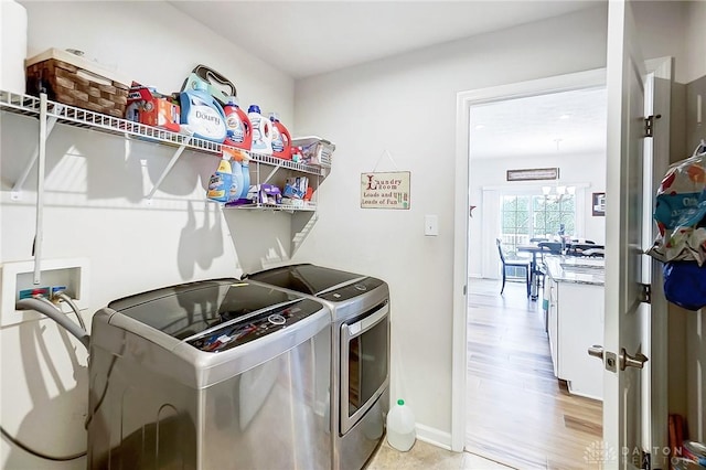 washroom featuring washer and dryer and light hardwood / wood-style flooring