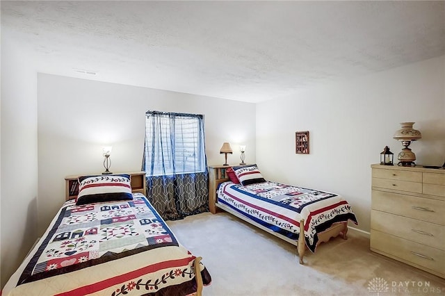 carpeted bedroom with a textured ceiling