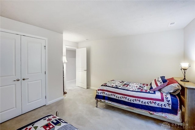 carpeted bedroom featuring a closet