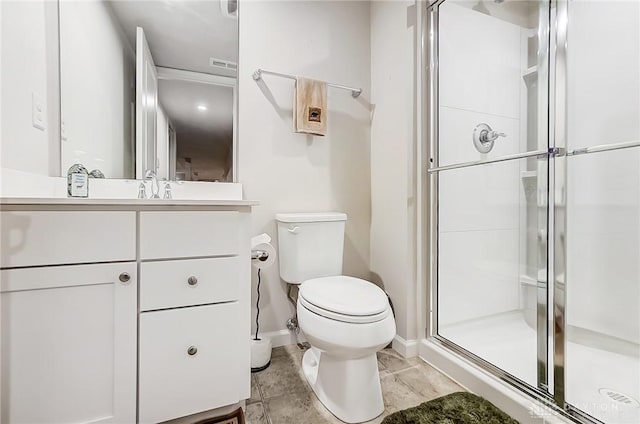 bathroom with vanity, toilet, and a shower with door