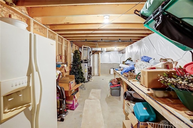 basement featuring white refrigerator with ice dispenser