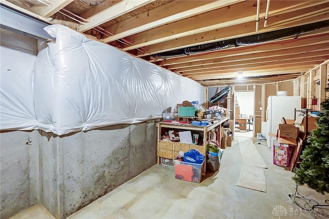 basement with white refrigerator