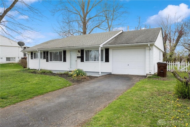 ranch-style home with a garage and a front lawn