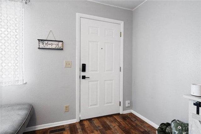 interior space with ornamental molding and dark wood-type flooring