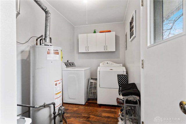 washroom featuring separate washer and dryer, dark wood-type flooring, cabinets, and gas water heater