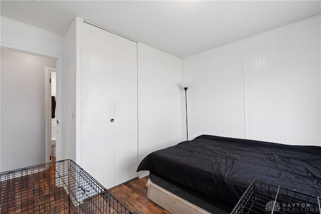 bedroom with dark hardwood / wood-style floors