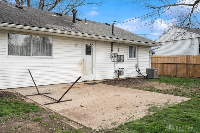 back of property with a patio area and central AC