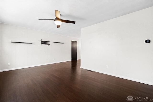 empty room featuring dark hardwood / wood-style floors and ceiling fan