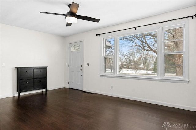 foyer featuring ceiling fan and dark wood-type flooring