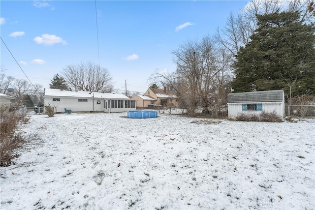 snowy yard with an outbuilding