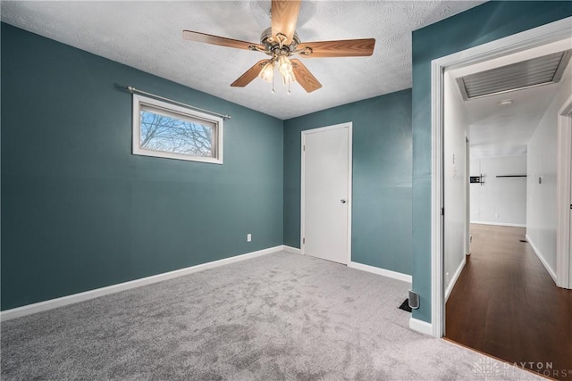 unfurnished bedroom with ceiling fan, a closet, carpet floors, and a textured ceiling