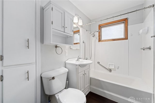 full bathroom with hardwood / wood-style floors, vanity, toilet, and shower / bathtub combination with curtain