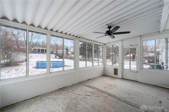 unfurnished sunroom with ceiling fan and vaulted ceiling