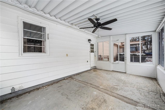 unfurnished sunroom featuring a wealth of natural light and ceiling fan