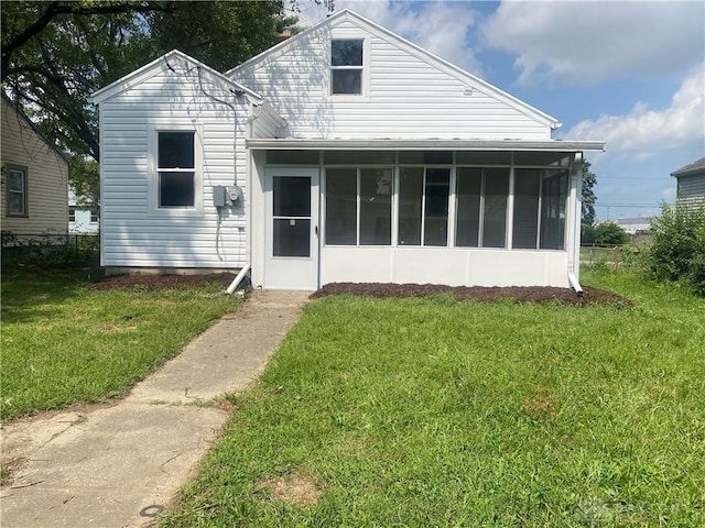 view of front of property with a front lawn and a sunroom