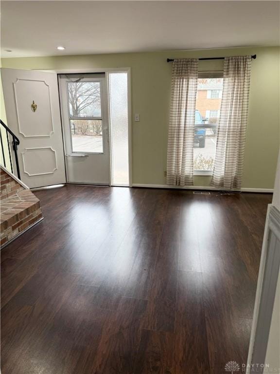 entryway with dark hardwood / wood-style flooring and a wealth of natural light