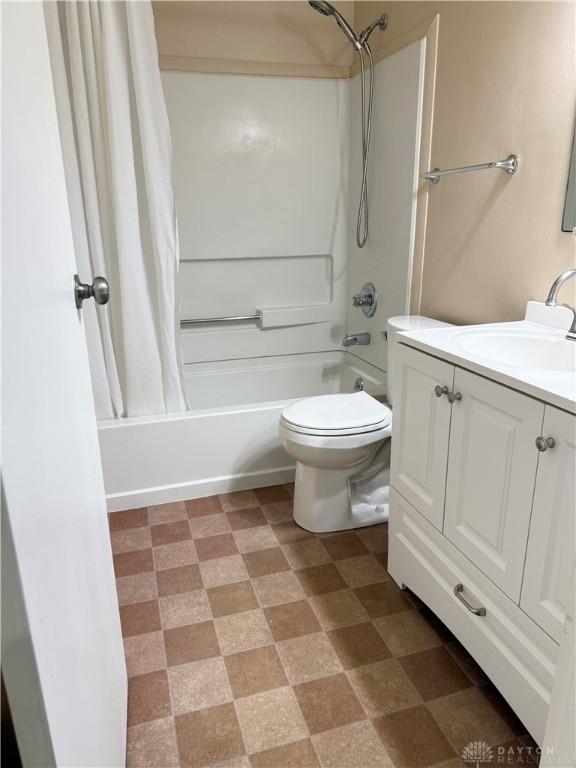 full bathroom featuring vanity, toilet, and shower / bath combo with shower curtain