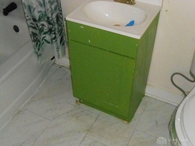 full bathroom with vanity, toilet, and shower / bath combo with shower curtain