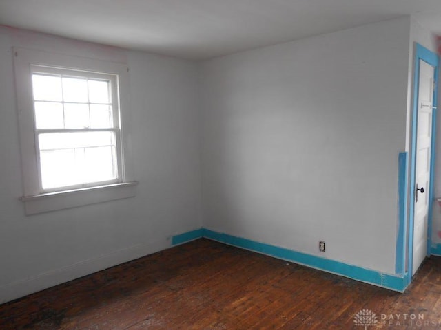 unfurnished room featuring dark hardwood / wood-style flooring