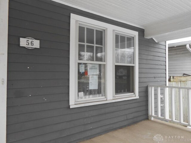 view of side of home with covered porch