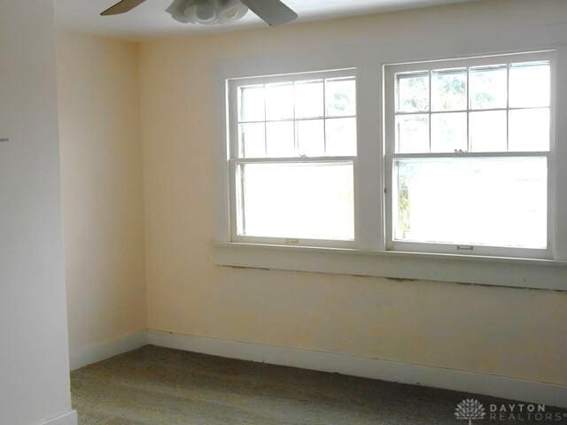 spare room with a healthy amount of sunlight and ceiling fan